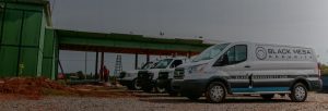 Black Mesa Security service vans parked orderly on job site